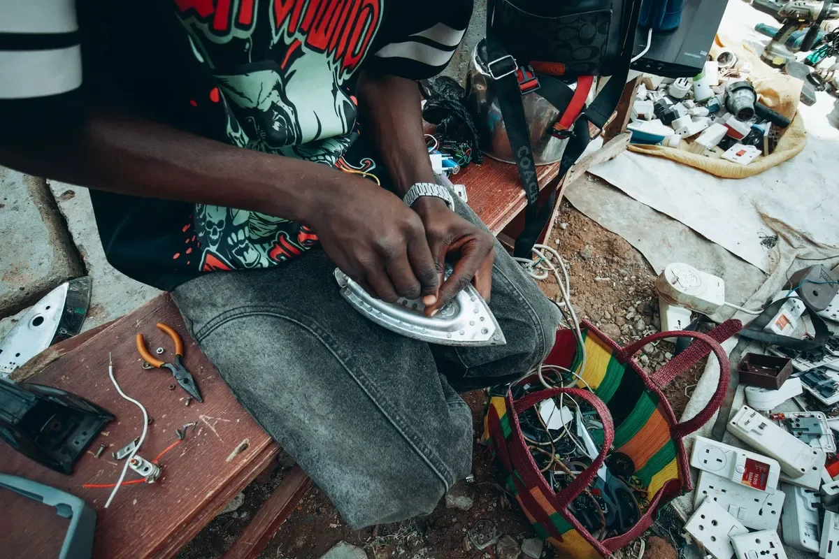 Repairing a device by hand, parts laid out on the bench (sample photo)